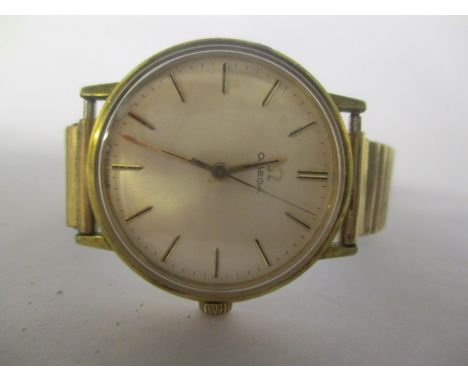 An Omega gents gold plated wristwatch having a silvered dial with baton numerals and on a later expanding bracelet 