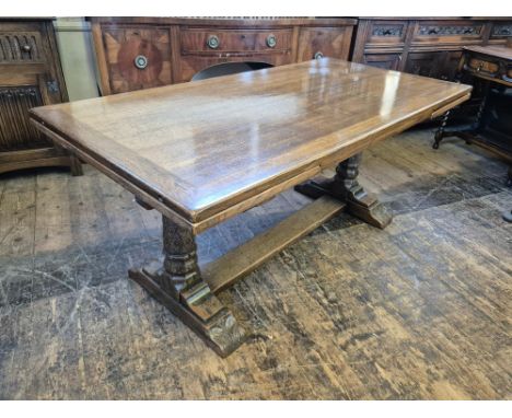 20th century distressed oak draw leaf refectory table, carved trestle base with hexagonal and turned supports, carved with bu