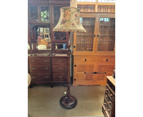 Heavy mahogany turned column standard lamp upon button foot base.
