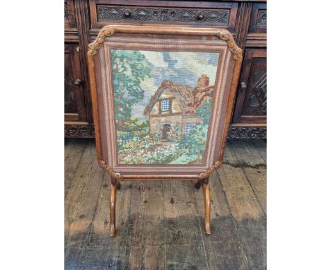 Walnut table fire screen with woolwork tapestry.