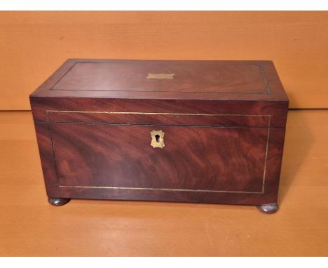 Victorian mahogany flame veneer tea caddy with brass stringing on bun feet.