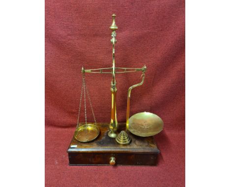 Set Victorian brass balance scales on mahogany single drawer base with set of Avery weighing scale weights, standing 65cm.