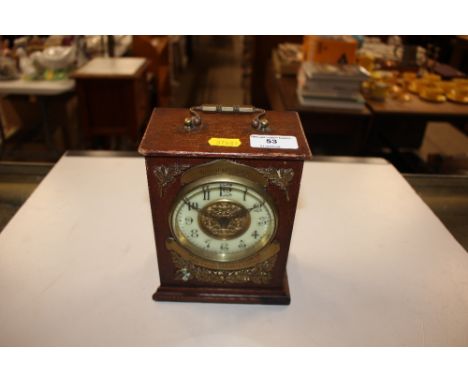 An early 20th Century oak cased and gilt metal mounted mantel clock with presentation inscription