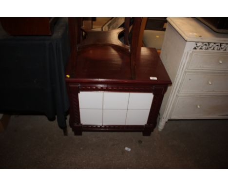 A wooden and tile linen box