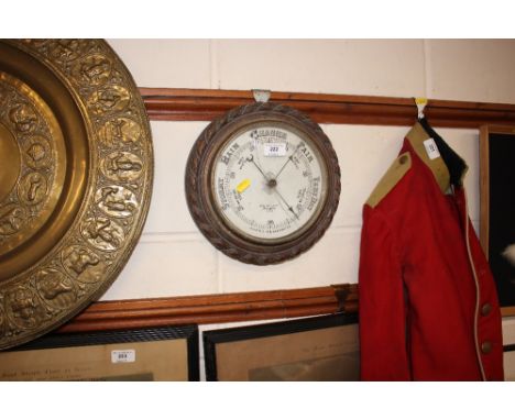 An oak cased aneroid barometer with rope twist decoration 
