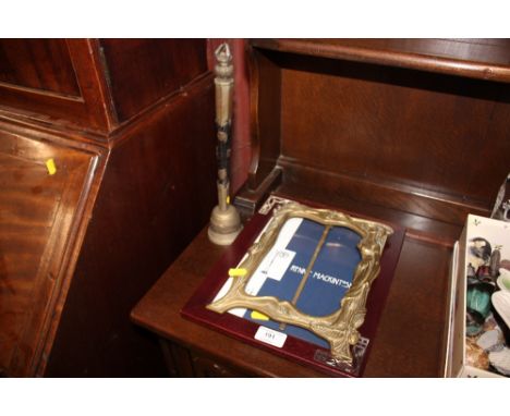 An Art Nouveau style brass easel mirror; together with Tibetan metal and wooden handled bell; and a Remy Mackintosh picture f