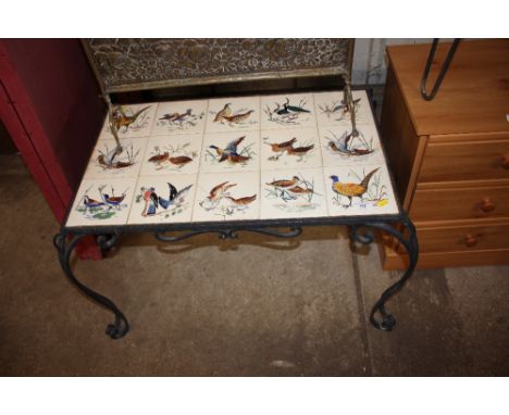 A French tile top table depicting various birds 