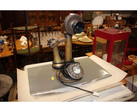 A candlestick telephone 
