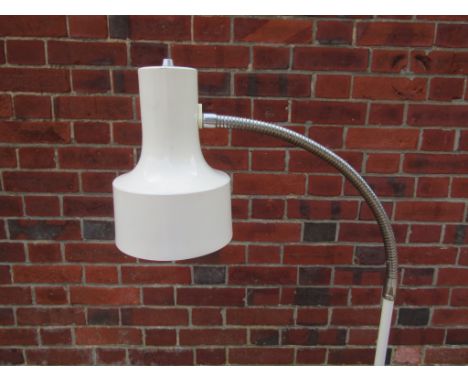 A white finish standard lamp with adjustable single spot light