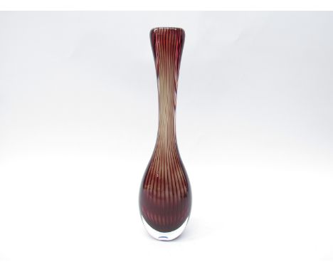 Kosta Glass - A tall slender glass vase with integral linear vertical decoration in cranberry colourway. Stamped Kosta mark a