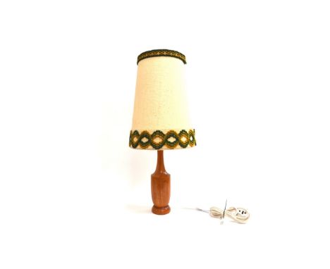 A teak based lamp with original woven shade 74cm high