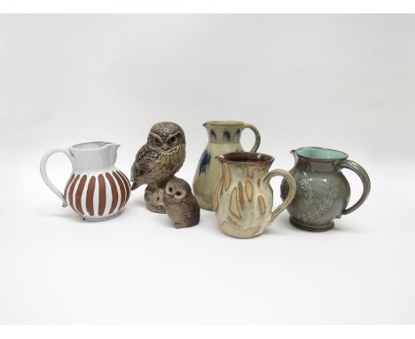 Four studio pottery jugs including Rye, Bakehouse Pottery etc plus two Poole Pottery owl figures. (6)