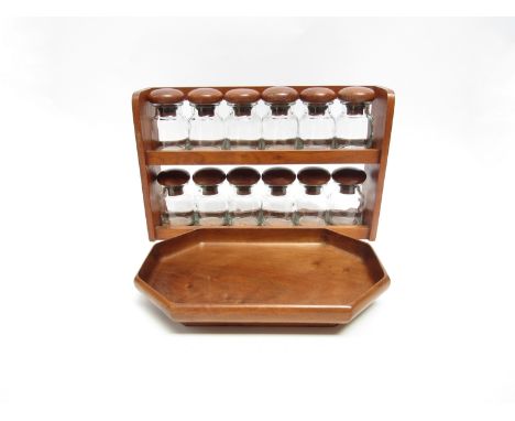 A 1970's teak spice rack with twelve glass jars, each with turned teak tops, together with 'A Jewell &amp; Co. Product' octag