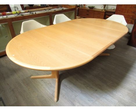 A Skovby circular oak extending dining table, model number RS18E with two extra leaves, 121cm diameter x 71cm high, each leaf