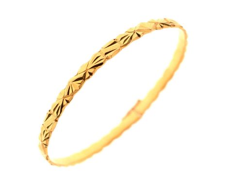 22ct gold bangle, stamped '22K', having geometric decoration, and a figure of eight safety clasp, inner diameter 60mm approx,