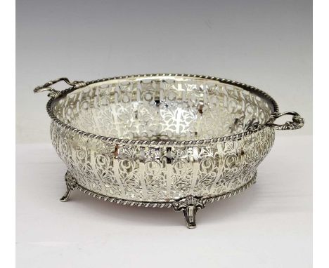 George V silver bowl with pierced floral decorated side, two cast handles, and standing on four feet, sponsor's mark of Adie 