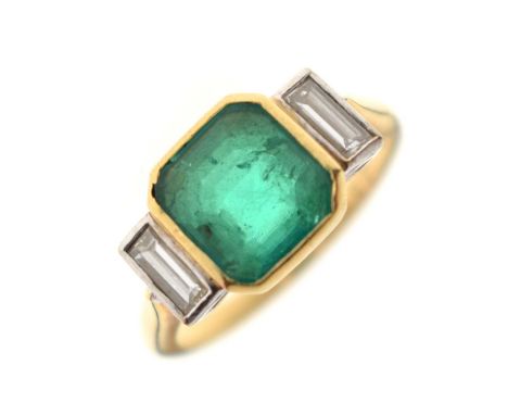 Emerald and diamond 18ct yellow gold and white gold set three stone ring, the central octagonal step cut emerald measuring ap