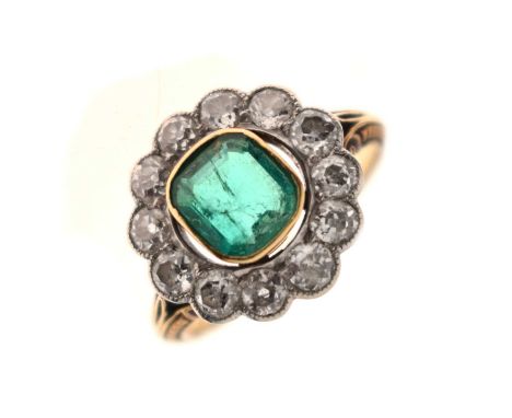 Early 20th century emerald and diamond 18ct yellow gold cluster ring, the emerald cut emerald measuring approx 7.0mm x 6.27mm