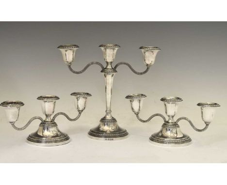 A suite of Elizabeth II silver candelabra, the low pair with engraved crest for the Hong Kong Police Force, the tall candlebr