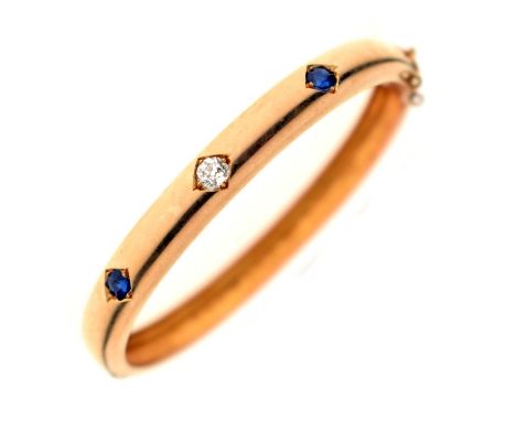 Victorian diamond and sapphire unmarked yellow metal hinged bangle, the central old mine cut diamond measuring approx 3.78mm 