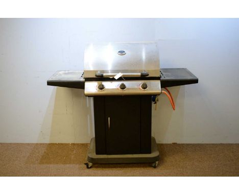 A 20th Century gas barbeque with three burners; together with a selection of barbeque tools.