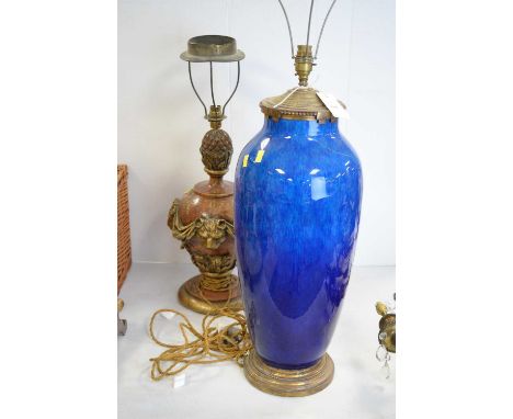 A large oval Sevres earthenware blue lamp base, with plated mounts and large cream shade; together with a carved wooden lamp 