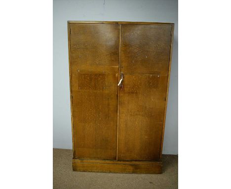 Compactum oak wardrobe, the caddy top with two cupboard doors enclosing hanging space and an arrangement of pigeon holes, rai