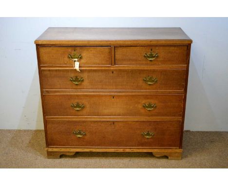 A late 19th Century oak chest of drawers, the rectangular top above an arrangement of two short over three long graduated dra