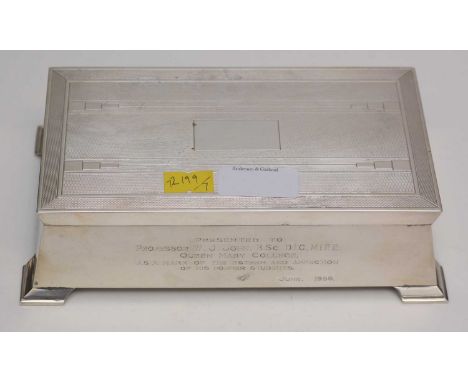 A silver-mounted cigarette box, by Alexander Clark, Birmingham, 1952, of sarcophagus form, with engine turned decoration and 