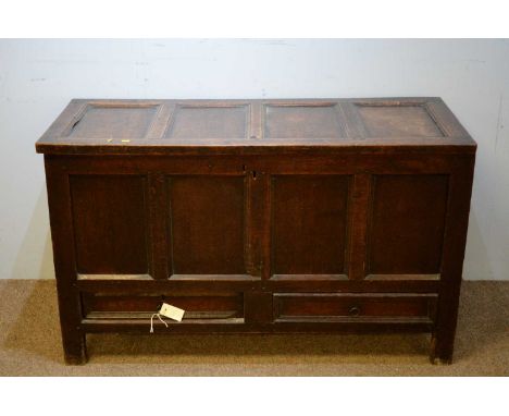 A George III oak mule chest, the four-panel hinged top, enclosing an interior above panelled front and sides with two short d