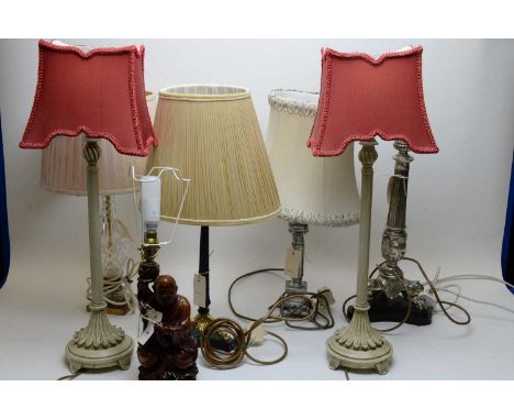 A Chinese hardwood lamp base in the form of a sage, fitted for electricity; two cream painted metal table lamps; two Neo Clas