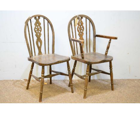 Two 20th Century elm Child's wheel back Windsor chairs, the first with hoop back, pierced splat and outswept arms, raised on 