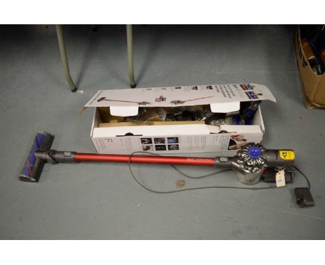 A Dyson B6 Total Clean vacuum cleaner, with various attachments, wall bracket and charger, boxed.