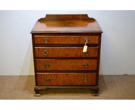 An early 20th Century walnut chest of drawers, with gallery back and rectangular top above an arrangement of four long drawer
