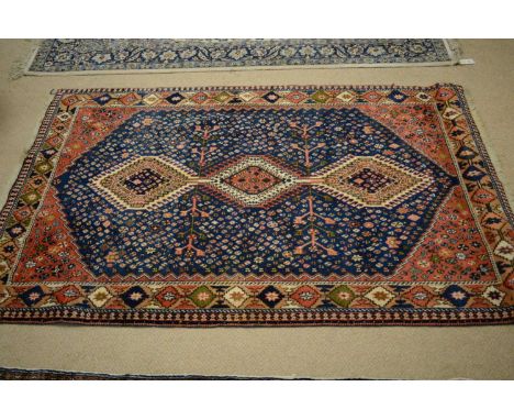 A Tabriz carpet, the indigo field with three central medallions enclosed by repeating geometric motifs, 160 x 109cms.