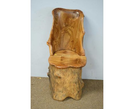 A Scottish elm carved trunk chair, with shaped back and hinged seat, inscribed 'Elm grown at Kellie Castle by Arncroch, Fife,