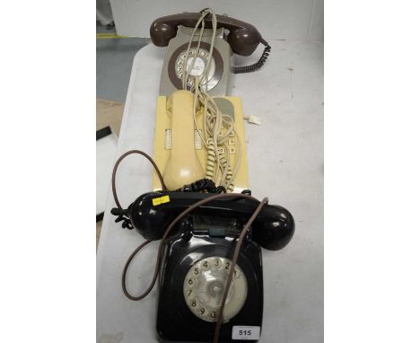 Three vintage telephone sets.