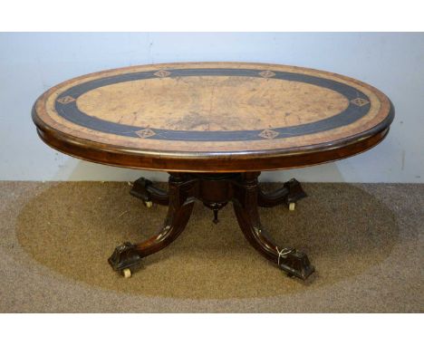 A late Victorian walnut coffee table, the oval top inlaid with Tunbridgeware lozenges raised on four turned supports and outs