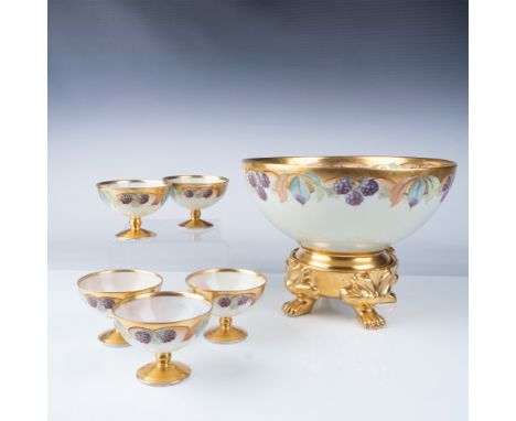 Antique porcelain punch bowl set comprising a large punch bowl, five matching footed punch cups, and a decorative footed base