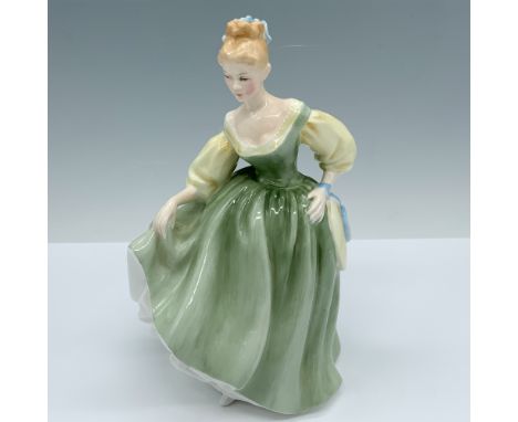 Handmade and hand decorated glossy figure of a dainty woman modeling a light green dress as she is likely inspired by the her