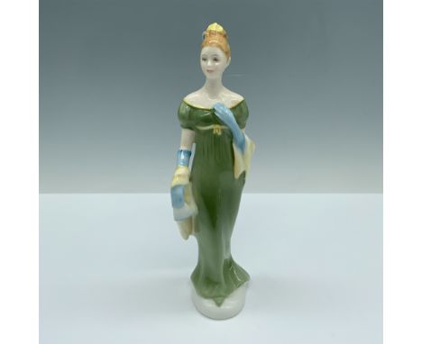 Handmade and hand decorated glossy figure of a woman modeling a long green gown that she styled with blue gloves and a yellow
