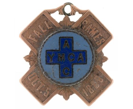 A YMCA MEDAL FOR THE FALL GAMES 1889, IN GOLD WITH BLUE ENAMEL, 2.6 CM LONG, 7G++SLIGHT ENAMEL DAMAGE