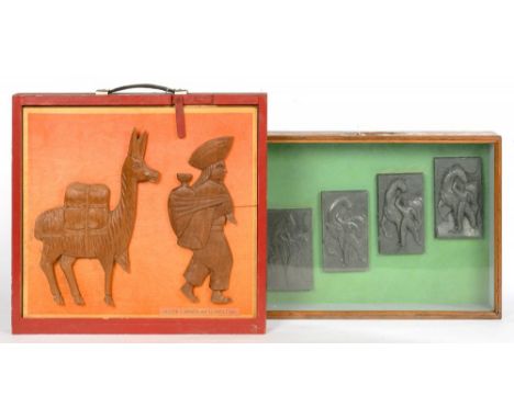 TWO DISPLAY CASES OF EXAMPLES OF RELIEF SCULPTURE, IN WOOD AND RESIN, 43 X 51CM EXCLUDING HANDLE, TWO AFRICAN WOOD, FUR AND S