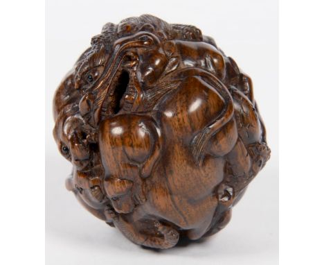 A JAPANESE CARVED HARDWOOD BALL NETSUKE OF ANIMALS, 5CM D