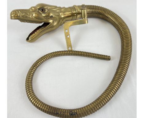 An early 20th Century brass car horn in the form of a Boa Constrictor's snake head. With graduating articulated tail pipe and