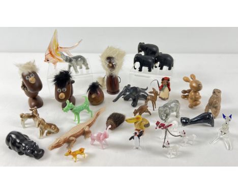 A collection of assorted vintage miniature animal figures to include glass, wood, ceramic, felt and plastic examples. 