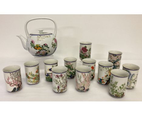 A 1980's Franklin Mint ceramic Japanese tea pot with floral detail, together with 12 tea cups. Each tea cup depicting a diffe