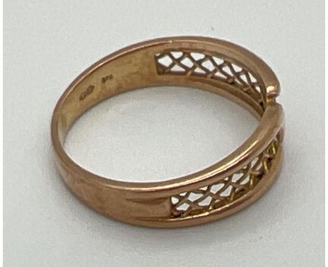 A vintage 9ct yellow gold band style ring with pierced panel detail of criss-cross design. Fully hallmarked inside band and s