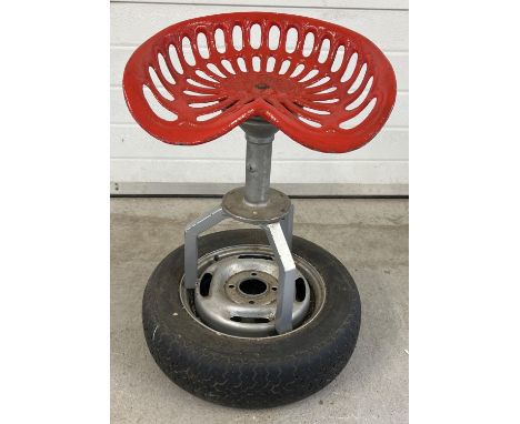 A custom made bar stool seat made from a Bamfords tractor seat. Dunlop wheel base with tripod pedestal and revolving cast met