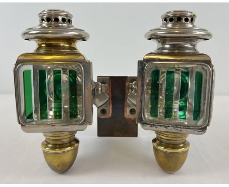 A pair of early 20th century French acetylene car lamps with green striped lenses. Mounted onto a copper back plate for wall 
